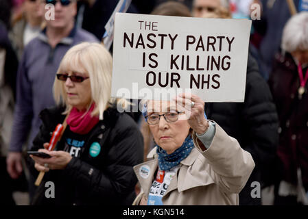 Nasty party killing NHS placard during Our NHS protest demonstration rally march against alleged UK Tory Conservative cuts and privatisation plans Stock Photo
