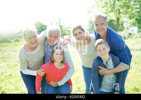 Intergenerational family walking together in park Stock Photo