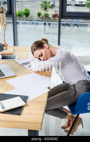 businesswoman sleeping on desk Stock Photo