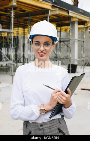 engineer in hardhat holding clipboard Stock Photo