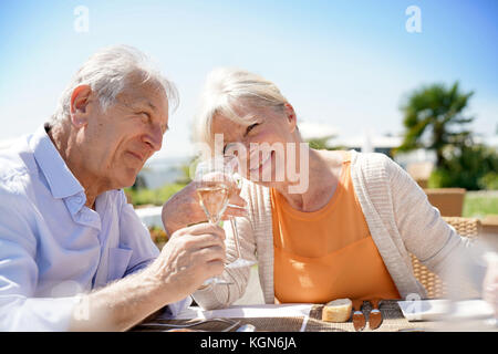 Senior couple enjoying meal in outdoor restaurant Stock Photo