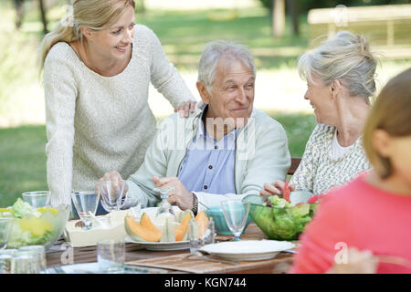 Family having summer lunch in garden Stock Photo