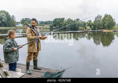 father and son fishing on lake Stock Photo