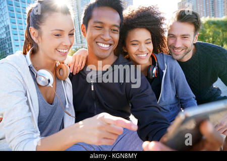 Group of friends in casual outfit taking selfie picture with smartphone Stock Photo