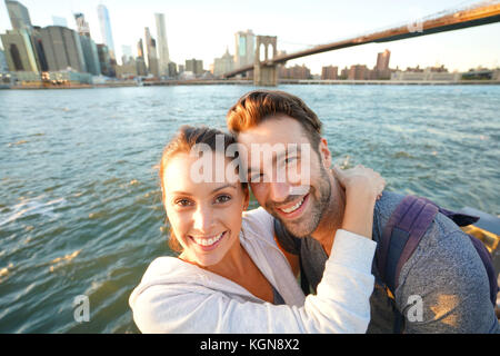 Couple embracing each other, Brooklyn bridge in background Stock Photo
