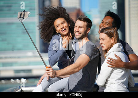 Group of friends taking selfie picture, Manhattan in background Stock Photo