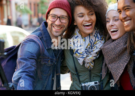 Group of friends on vacation taking selfie picture with camera Stock Photo