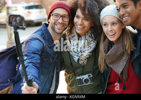 Group of friends on vacation taking selfie picture with camera Stock Photo