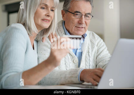 Senior couple buying on internet with credit card Stock Photo