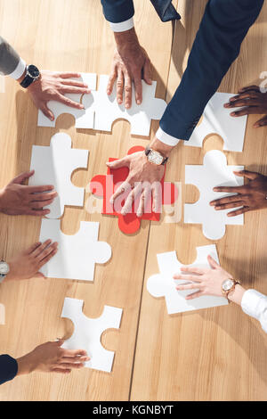 assembling puzzle Stock Photo