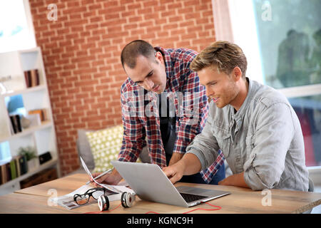 Young men studying in front of laptop Stock Photo