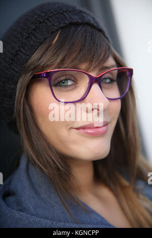 Portrait of young trendy girl on dark background Stock Photo