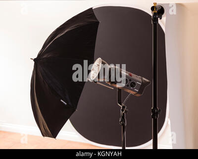 Photographic studio equipmemnt, Bowens flash, roll paper backdrop, and folding black back drop. Stock Photo