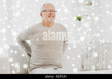 unhappy senior man suffering from backache at home Stock Photo