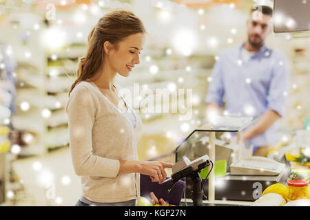 woman buying food at grocery store cash register Stock Photo