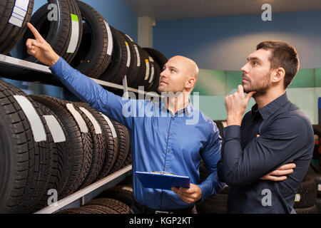 customer and salesman at car service or auto store Stock Photo