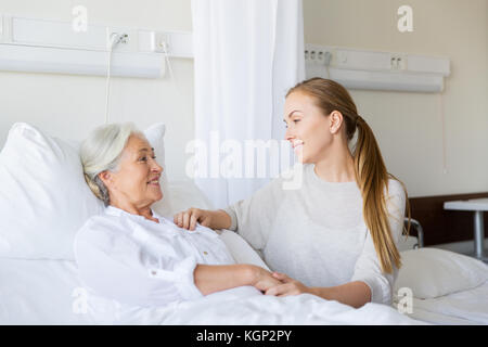 daughter visiting senior mother at hospital Stock Photo