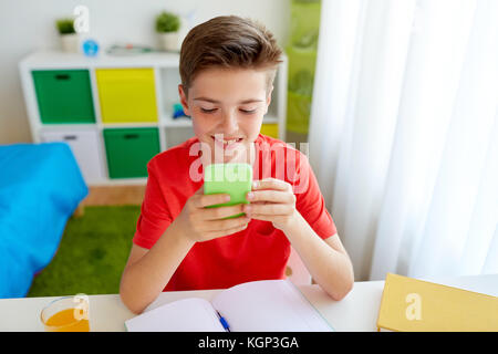 Teen boy distracting from online lesson and playing video games, scrolling  phone. Learning difficulties, online education, entertainment at home Stock  Photo - Alamy