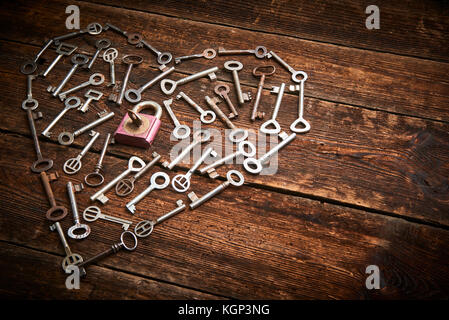 Old keys in a heart shape, on a wood surface, vintage look Stock Photo