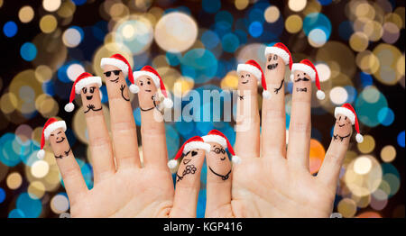 hands and fingers in santa hats at christmas Stock Photo