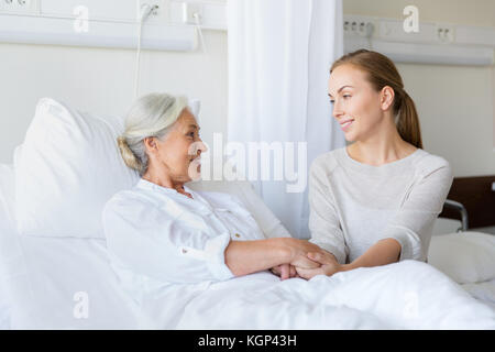 daughter visiting senior mother at hospital Stock Photo
