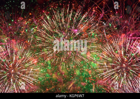 Colorful bright fireworks against dark sky Stock Photo