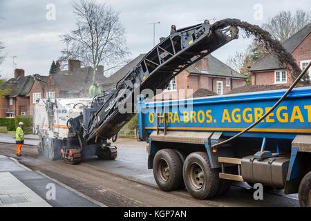 Roadworks to resurface the tarmac of a residential road in London, UK Stock Photo