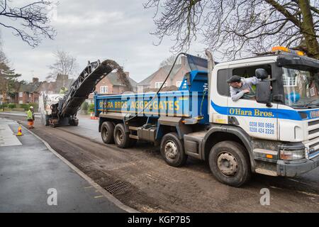 Highway contractors resurface the tarmac of a suburban road in London, UK Stock Photo