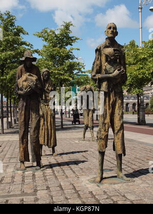 The Famine Memorial along the Liffey River in Dublin, Ireland. The statures depict the Irish leaving for outbound ships during the potato famine. Stock Photo