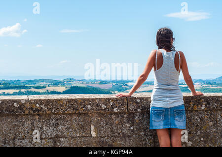 Woman admiring the summer Italian landscape in Montepulciano, Tuscany, Italy. Stock Photo