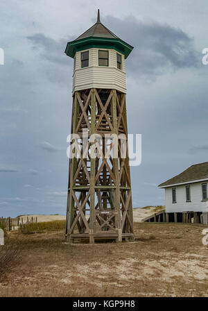 Old wooden water tower with keeper room over blue sky Stock Photo - Alamy