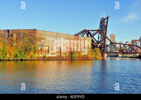 Water in the South Branch of the Chicago River creates a reflection of a warehouse and the lowered and raised railroad bridges. Chicago, Illinois, USA. Stock Photo