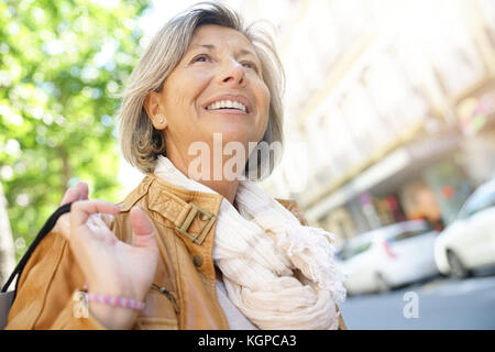 Portrait of senior woman in town on shopping day Stock Photo