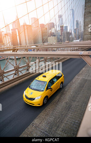 Taxi cab riding on Brooklyn bridge Stock Photo