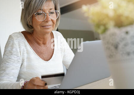 Senior woman buying on internet with credit card Stock Photo