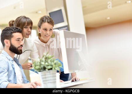 team of designers working on desktop Stock Photo