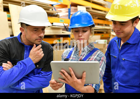 Carpentry teacher using tablet to train apprentice Stock Photo