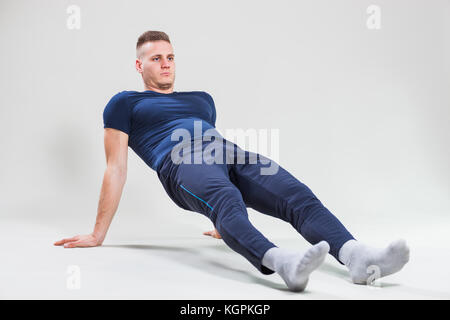 Studio shot image of young man who is doing push-ups. Stock Photo