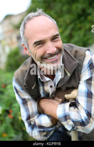 Portrait of senior gardener in vegetable garden Stock Photo