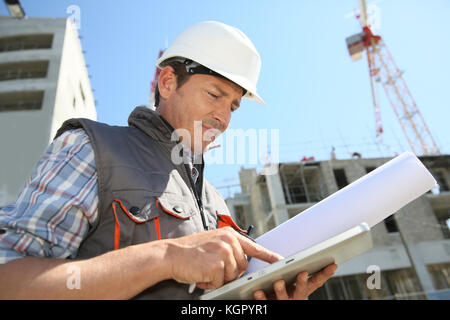 Entrepreneur on building site using tablet Stock Photo