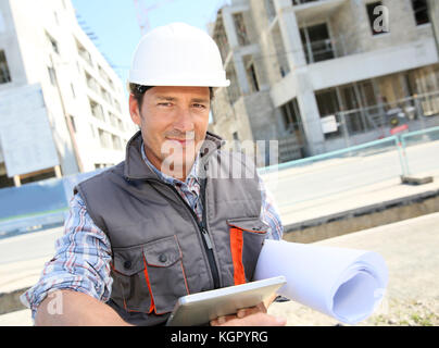 Entrepreneur on building site using tablet Stock Photo