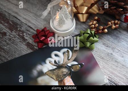 Still life with christmas card, tree decorations and bows Stock Photo