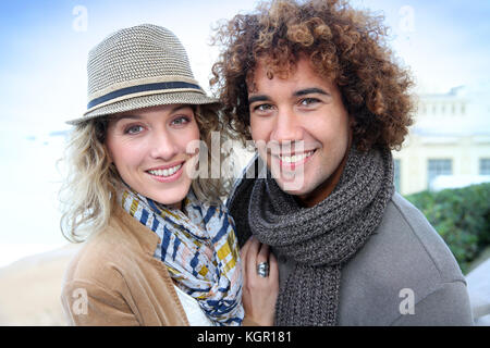 Trendy cheerful couple out in town Stock Photo