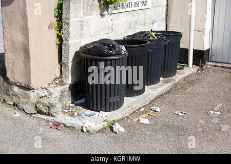 black plastic refuse bins with residents use only sign Stock Photo