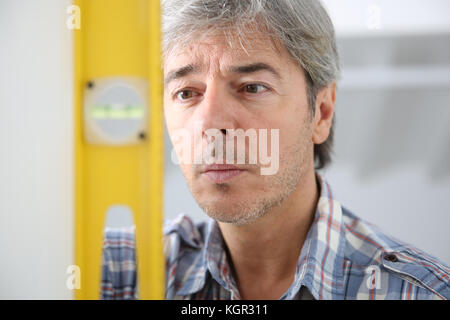 Closeup of craftsman using level Stock Photo