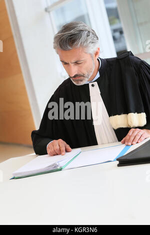 Mature lawyer working on judgement report Stock Photo