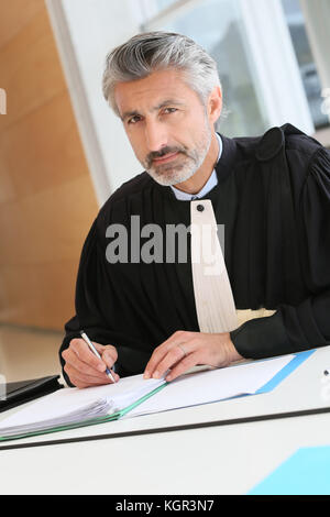 Mature lawyer working on judgement report Stock Photo
