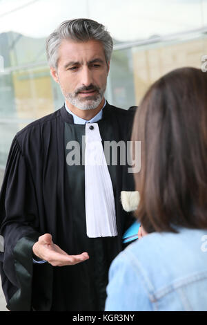 Lawyer meeting client in courthouse before trial Stock Photo