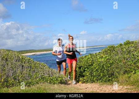 Couple running by the sea on track Stock Photo