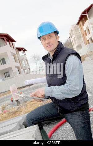 Supervisor using electronic tab on construction site Stock Photo